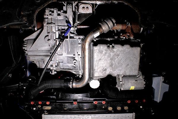 Underbody shot of the stock intercooler piping on a 2013 Ford Focus ST